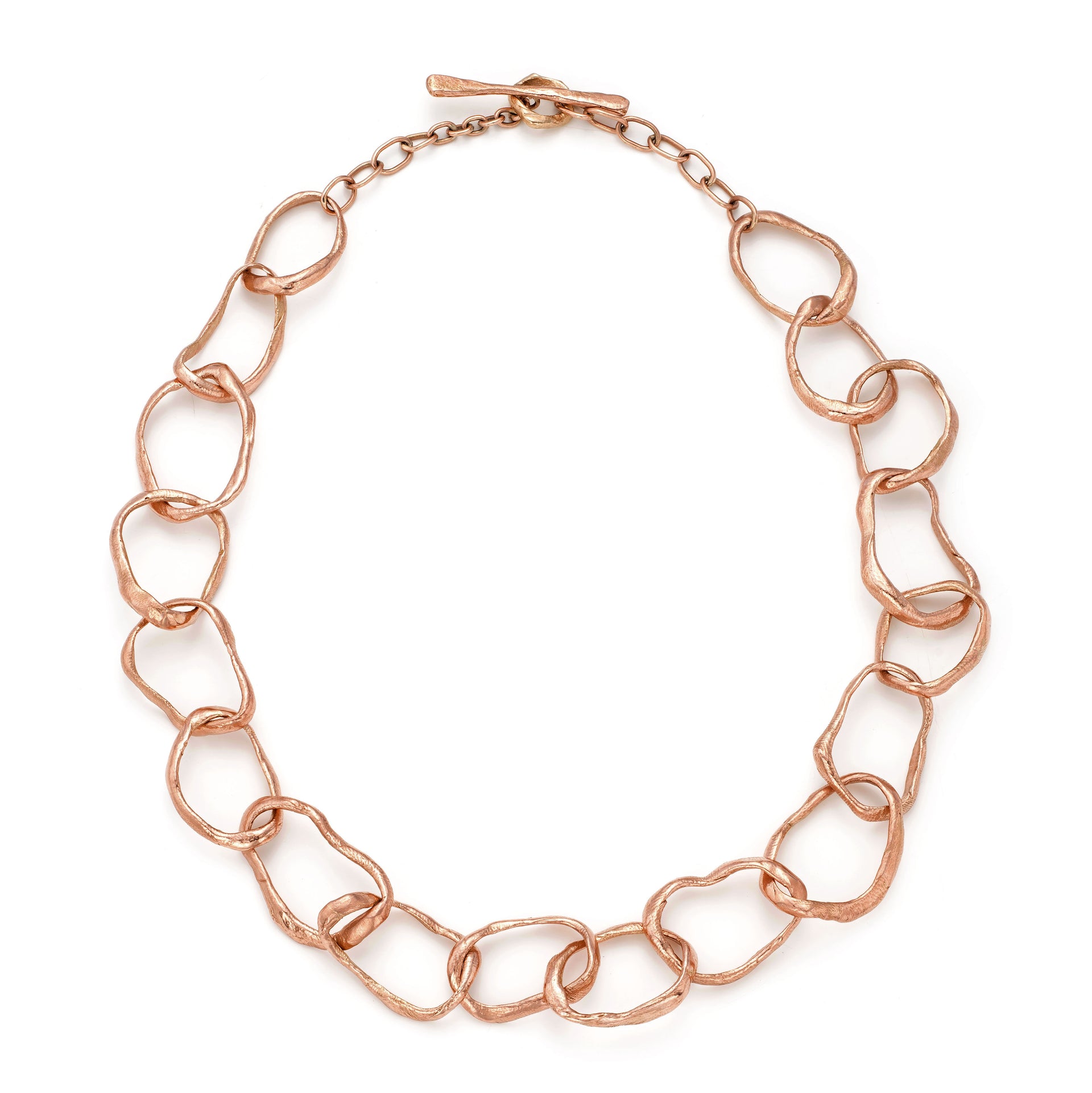 Unconventional rose gold chain necklace by Cornwall jewellery designer Emily Nixon. Each irregular link has been handmade to vary in size. The solid 9ct gold retains a rich lustre without being overly shiny. The necklace can be worn at different lengths: neck choker or longer. Emily’s signature sea worn finish gives the impression of sea tumbled treasure, jewellery handmade in Cornwall, made tactile by the tide. 