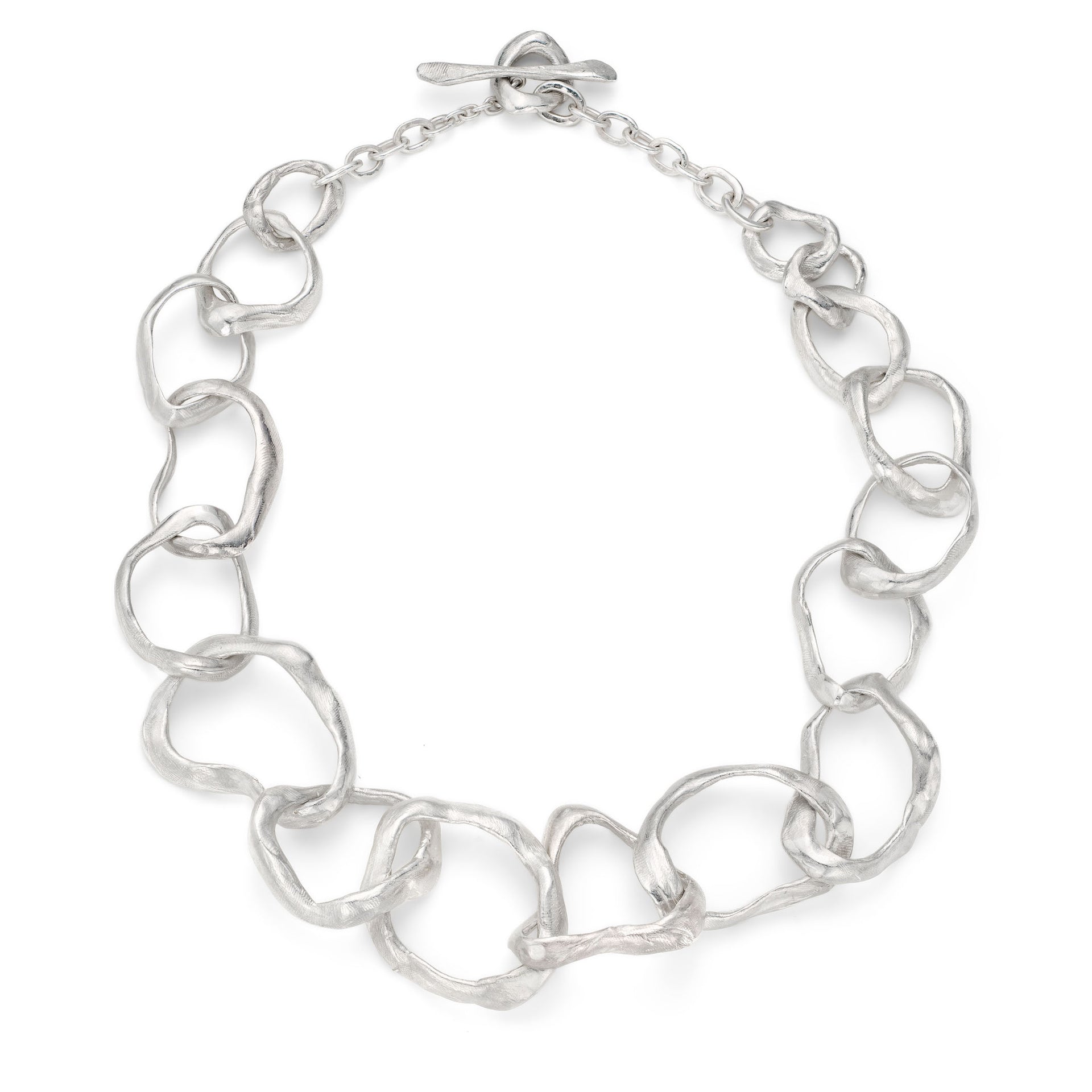 Large irregular sterling silver links, moulded by hand to create a sculptural, coastal necklace. The classic, signature design in this Cornwall jewellery designers organic jewellery range. Chunky links follow the form of beach pebbles, interconnected to create this large link silver chain necklace. A classic organic, coastal design in the natural, unconventional style of Emily’s jewellery.