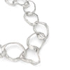 Detail of Emily Nixon’s classic Rock Drawing chunky link silver necklace. Each link has been handmade to have a tumbled, sea worn character. The tools of her jewellery making process - stones, pebbles and rocks - are pressed into the very surface to create the raw, made by hand finish she is known for. Organic and intrinsically coastal jewellery handmade in Emily’s studio on the outskirts of St Ives and cast just 5 miles south near Penzance. A truly locally crafted piece of contemporary jewellery design.