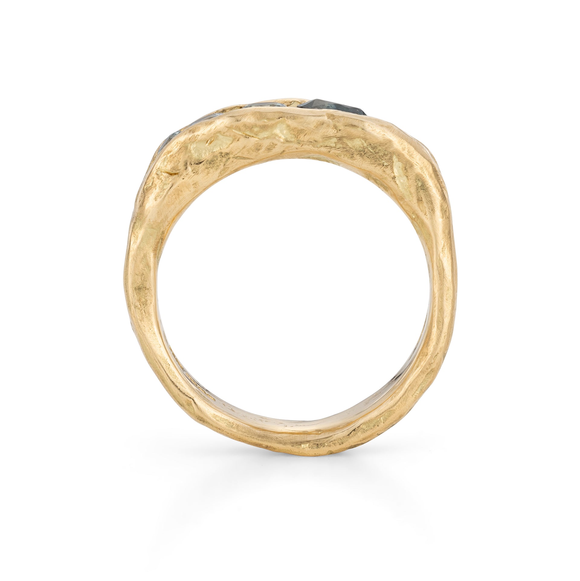 Icy blue sapphires that appear to be caught in a ravine of 18ct yellow gold, with a character as if formed by nature. By Emily Nixon.