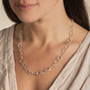 Fine links formed around the contours of little sea-worn pebbles ;A beautifully tactile necklace with a refined, organic character. By Emily Nixon