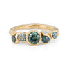 This unique Nori ring is set with ocean teal sapphires in a 18ct yellow gold band. By Emily Nixon