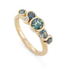 This unique Nori ring is set with ocean teal sapphires in a 18ct yellow gold band. By Emily Nixon