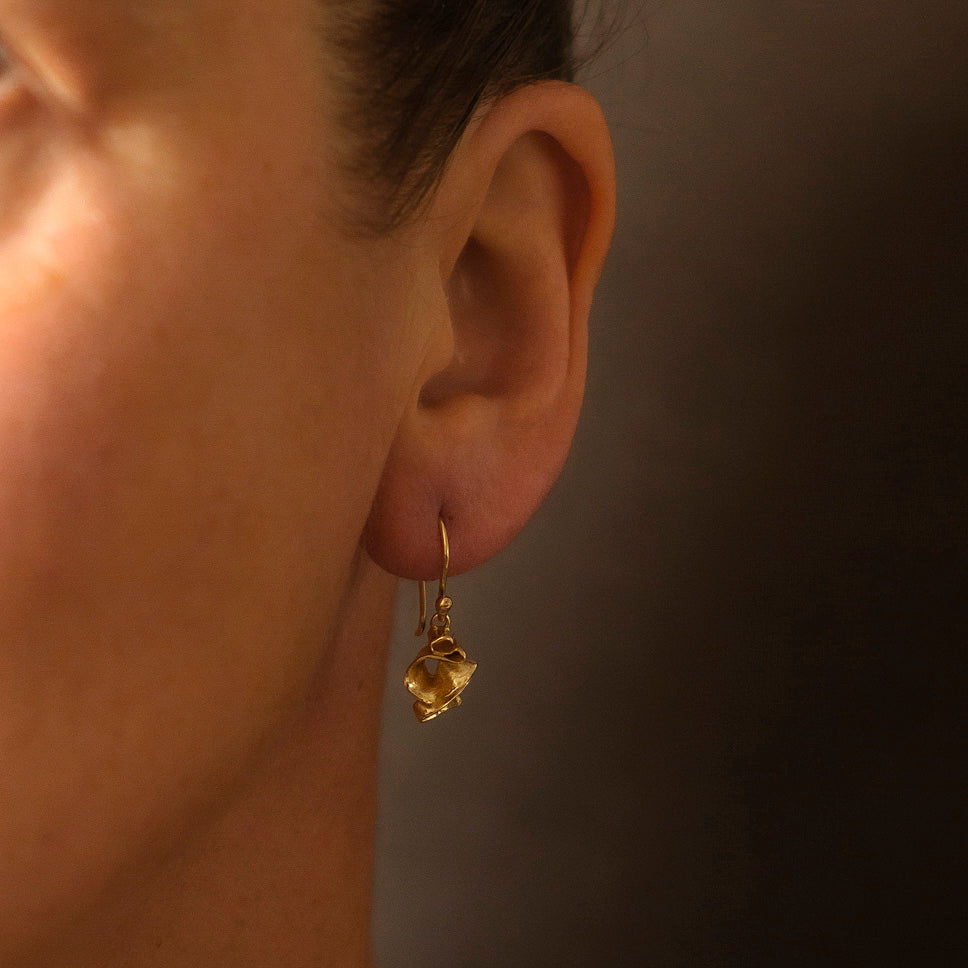 Sculptural earrings in 18ct yellow gold, suspended on hand drawn 18ct gold wires. Made in the Cornish studio of Emily Nixon.