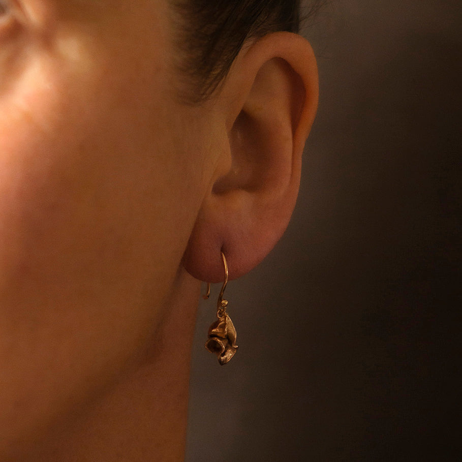 Sculptural earrings in 9ct rose gold, suspended on hand drawn 18ct gold wires. Made in Cornwall by Emily Nixon.