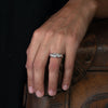 A diamond and platinum engagement ring, shown on a model, with a platinum ripple textured band.