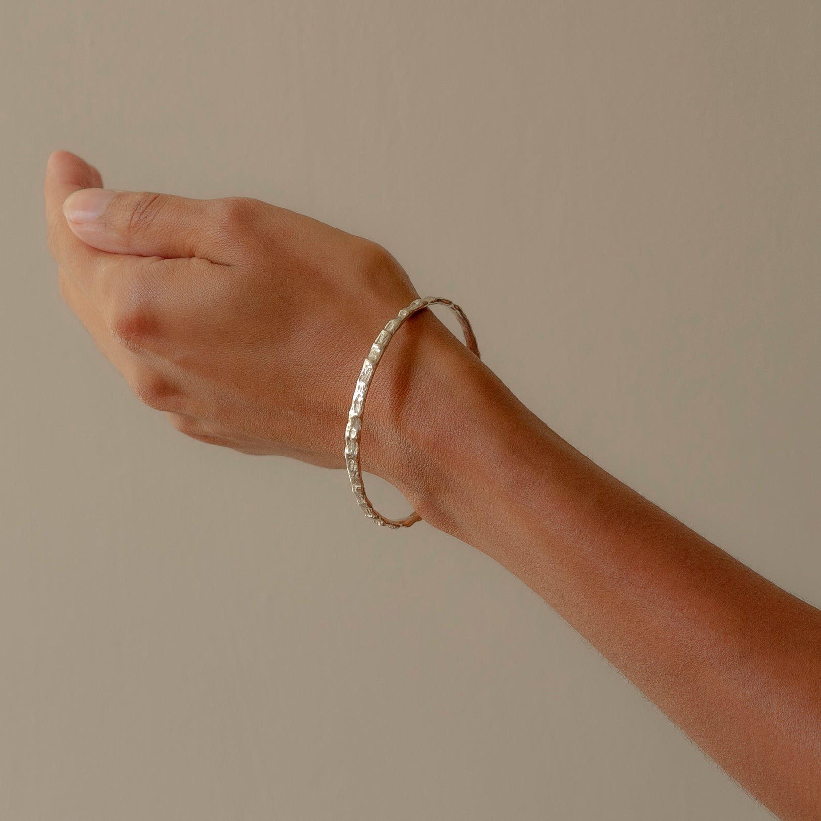 Model wearing a handmade Cockle Bangle in silver
