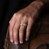 18ct gold and diamond engagement ring set in an unusual, sea worn texture, with 6 diamonds. Photographed on a models hand.