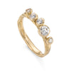 Upright front view of a sustainably sourced 18ct gold and diamond engagement ring by Emily Nixon, set with 5 diamonds.