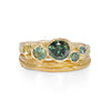 Unconventional wave textured handmade wedding band stacked with rockpool green sapphire engagement ring.