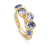 An unusal gemstone ring of icy blue and cornflower sapphires in 18ct yellow gold.