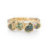 Organic designed gemstone ring with rich rock pool green sapphires.