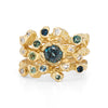 Gemstone stacking rings in organic design set with light and deep teal sapphires and diamonds.