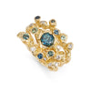 Stacking rings in gold set with teal sapphires and diamonds.
