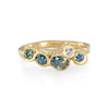 Teal sapphires are set in an organic pebble inspired gold ring. The sea colours of these ethically sourced gems creates a forever ring reminisce of the ocean. 