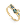 Sea inspired alternative engagement ring. Ocean and teal coloured ethical sapphires are set in an organic gold ring.