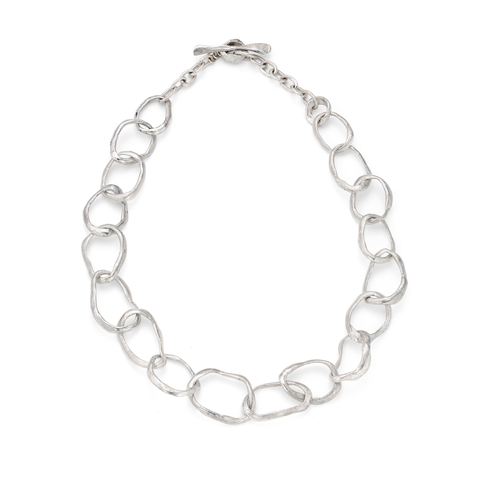 This unique, sculptural, large chain jewellery design is inspired and handmade on the coast of Cornwall. Individually made, chunky stone shaped links are deliberately different, creating a non uniform chain of irregular links. Unconventional with an arty style, this unusual silver necklace is intrinsically coastal and an Emily Nixon classic design. Finish is natural, the surface a sea worn, tumbled, tactile white silver. 