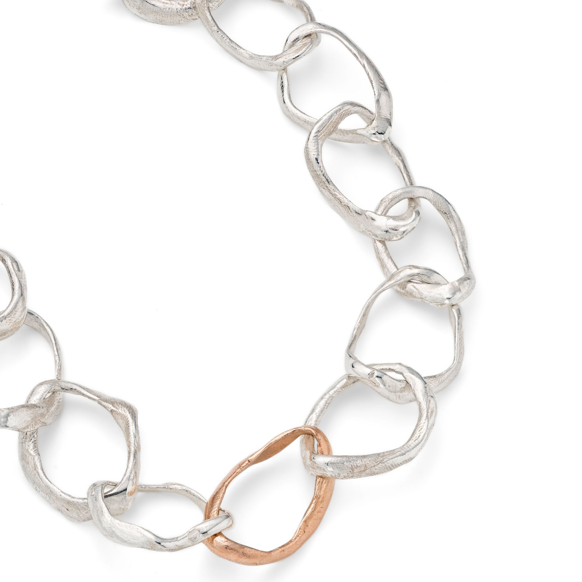 Detail of the hand crafted, irregular, solid silver and rose gold links that make up the chain in Emily Nixon's Stone Drawing Necklace. Each link has been handmade to be different. The silver and gold chain links retain a lustre without being overly shiny. Tactile and utterly wearable, a relaxed gold necklace to put on everyday by Cornwall jewellery designer Emily Nixon.