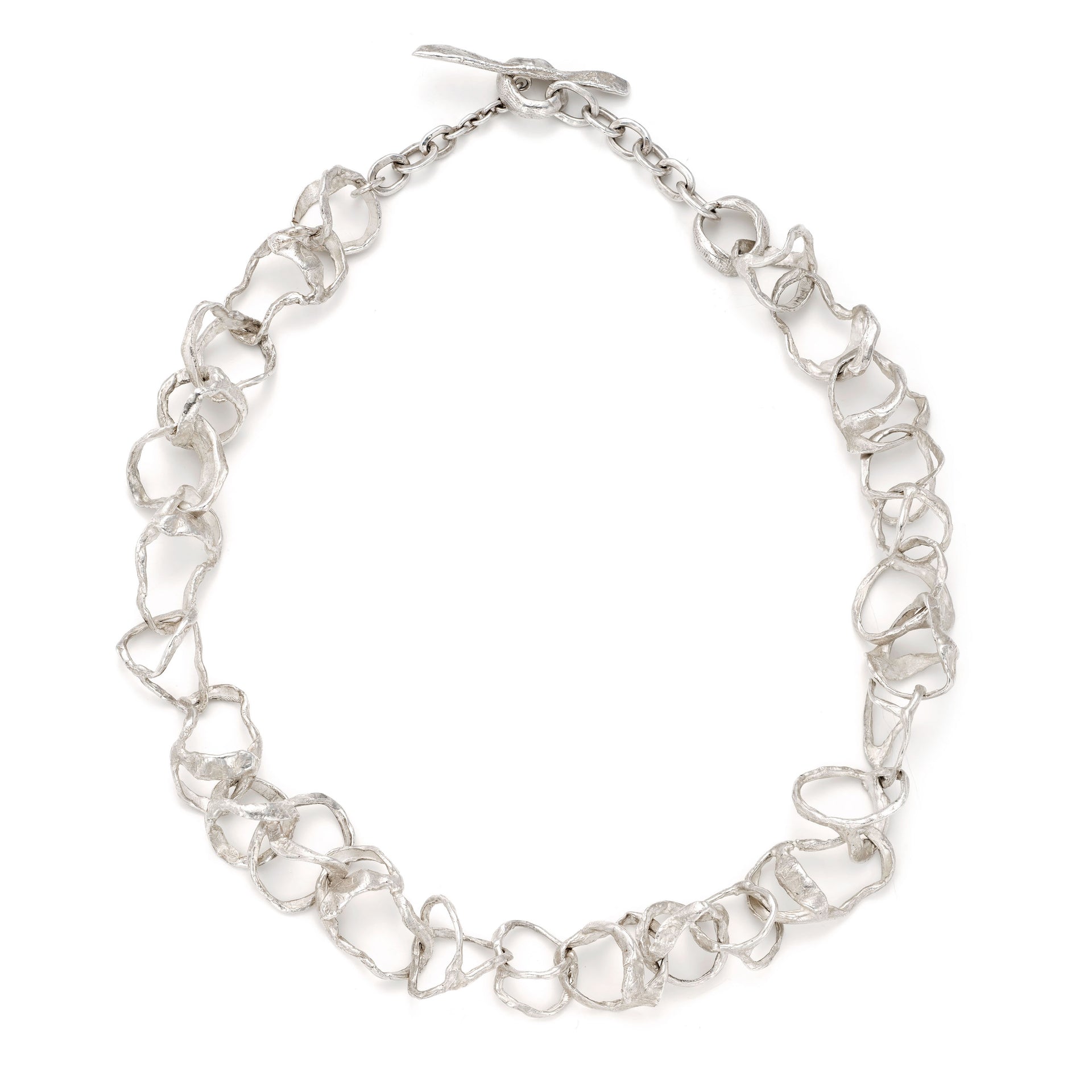 A line of 'tangled' organic links that moves freely. Handcrafted, solid silver T-bar finished with the a tumbled, sea-worn surface. By Emily Nixon.
