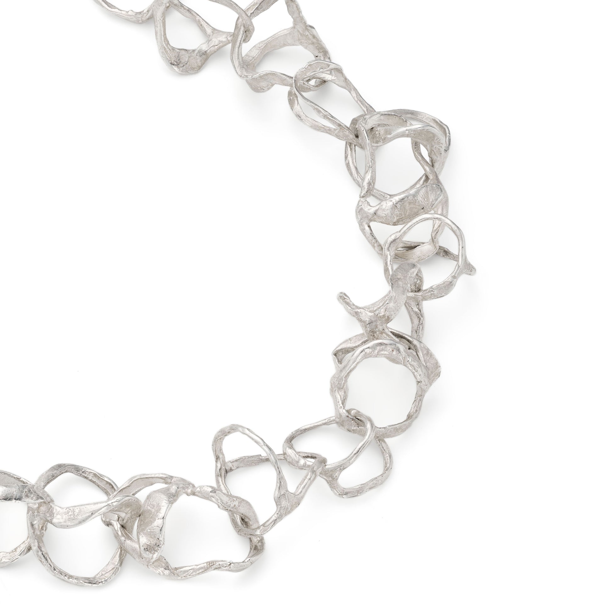 A line of 'tangled' organic links that moves freely. Handcrafted, solid silver T-bar finished with the a tumbled, sea-worn surface. By Emily Nixon.