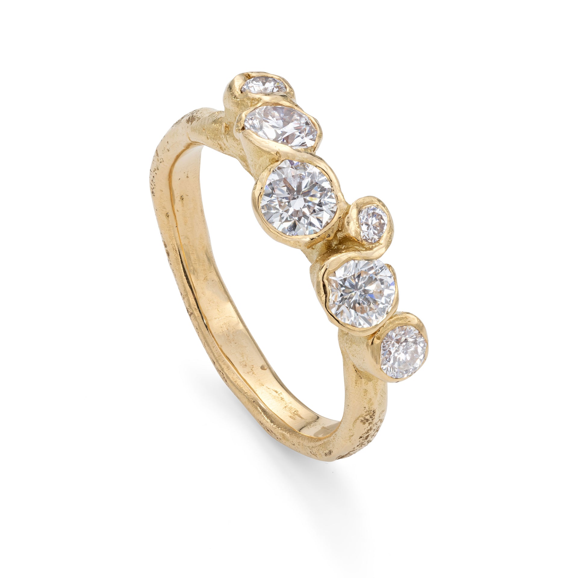 Upright, front view of a diamond and 18ct gold engagement ring. This ring has a sea worn texture and has been organically designed by Emily Nixon.