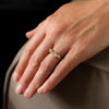 An ethically sourced diamond and 18ct gold engagement ring by Emily Nixon, photographed on a models hand.