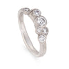 An upright front view of an alternative diamond engagement ring by Cornish jeweller, Emily Nixon.