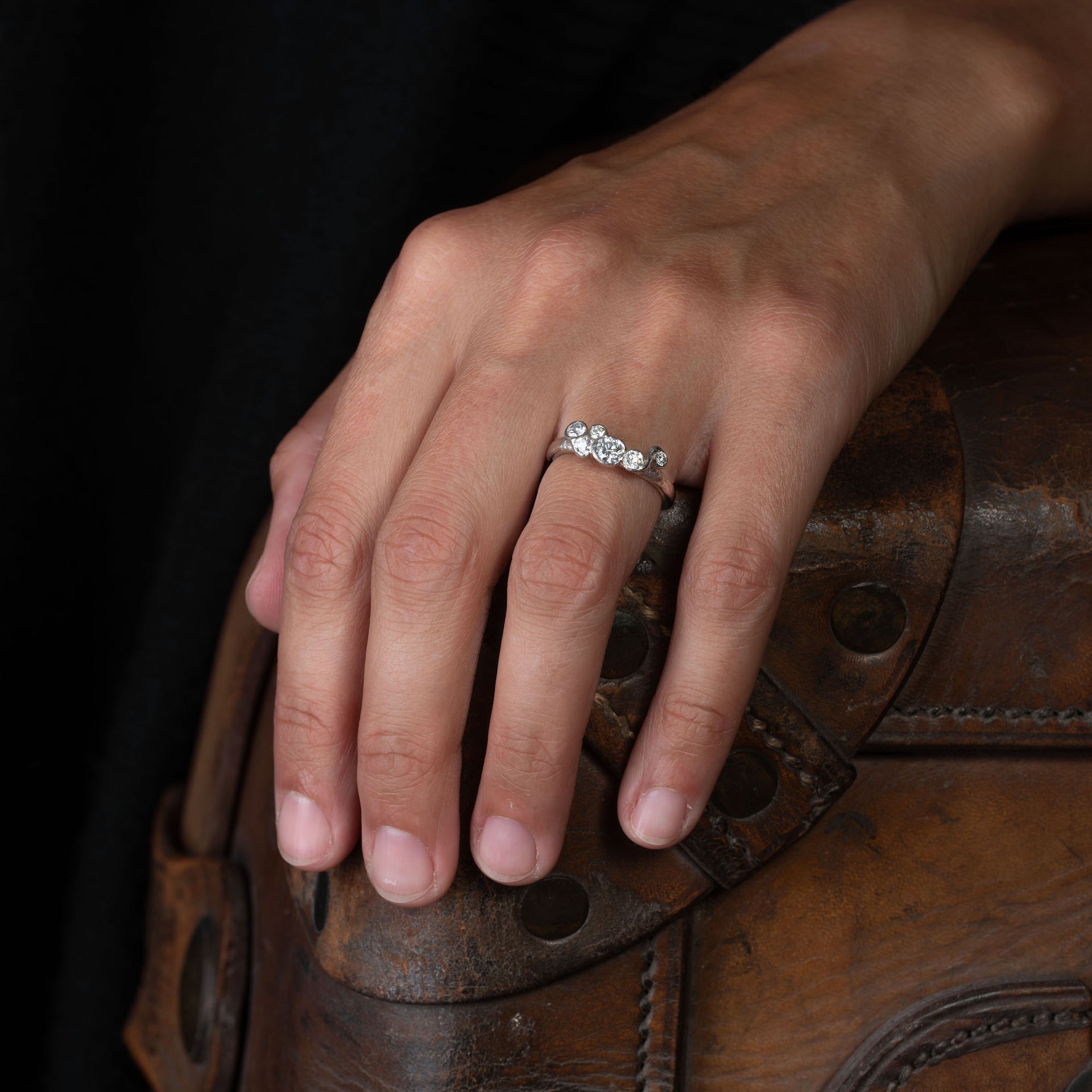 A diamond and recycled platinum engagement ring by Cornish jeweller, Emily Nixon. The ring is shown here on a model.
